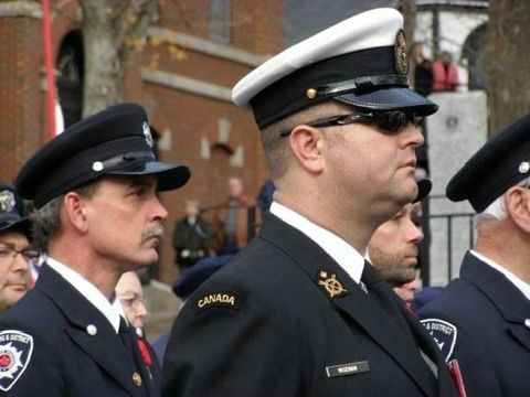 Firefighters in dress uniform at a remembrance ceremony