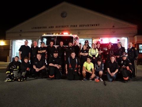 Members of Lunenburg and District Fire Department in front of their station at night